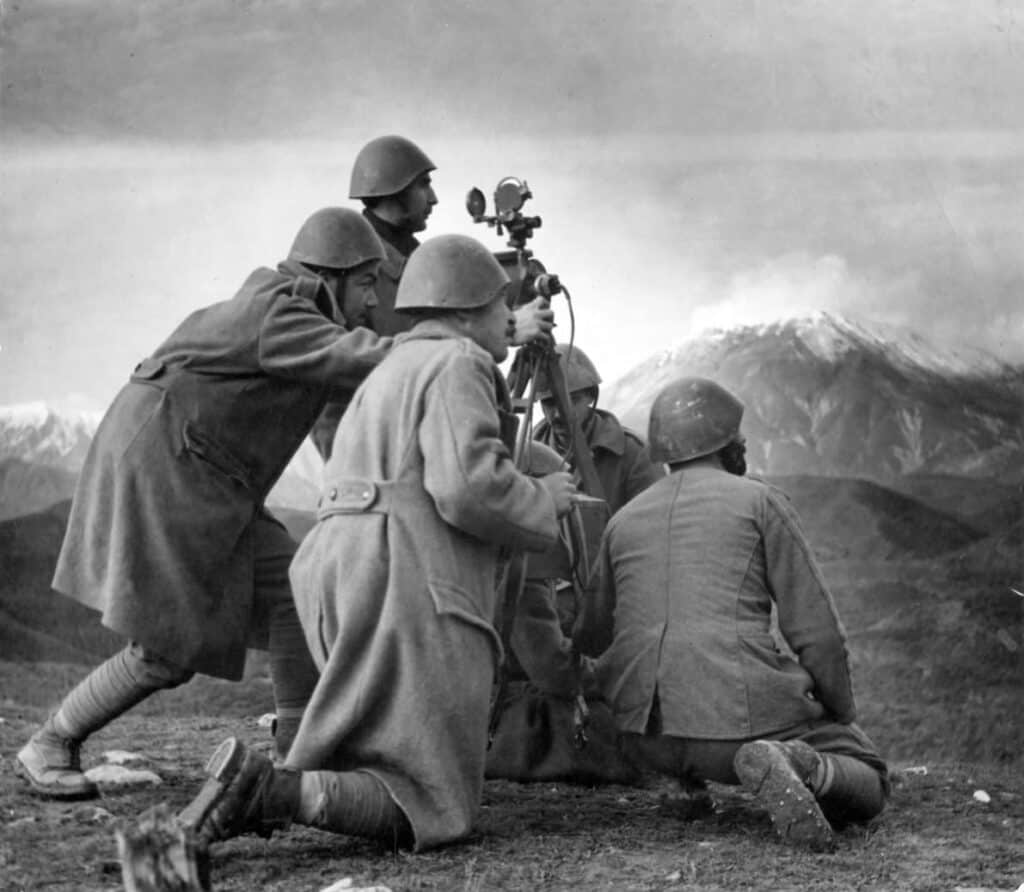 Greek Army soldiers use a rangefinder to target invading enemy Italian positions in the Pindus mountain range during the Greco-Italian War.