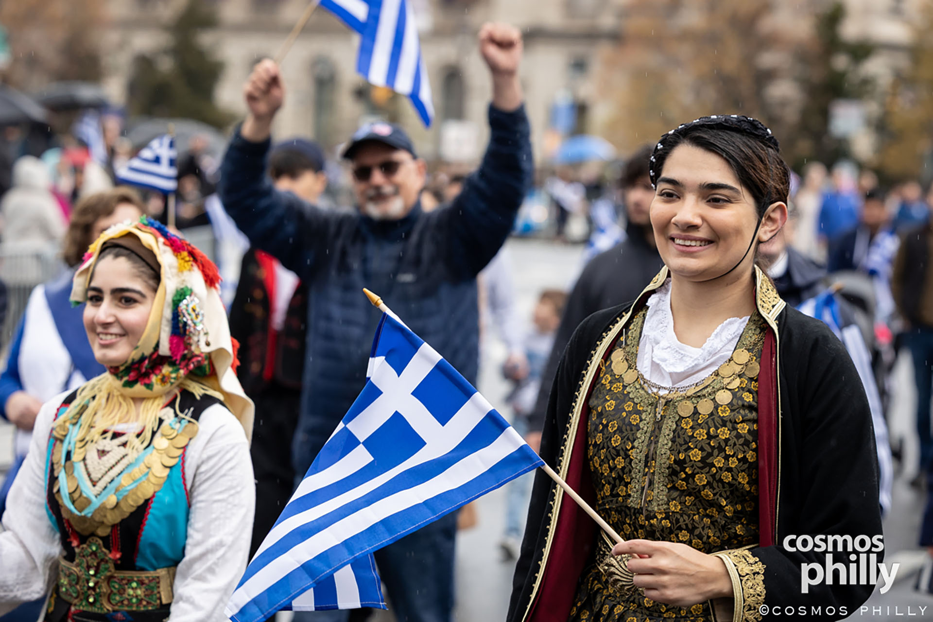 Participants in traditional Greek attire carry flags during the Greek Independence Day parade in Philadelphia.