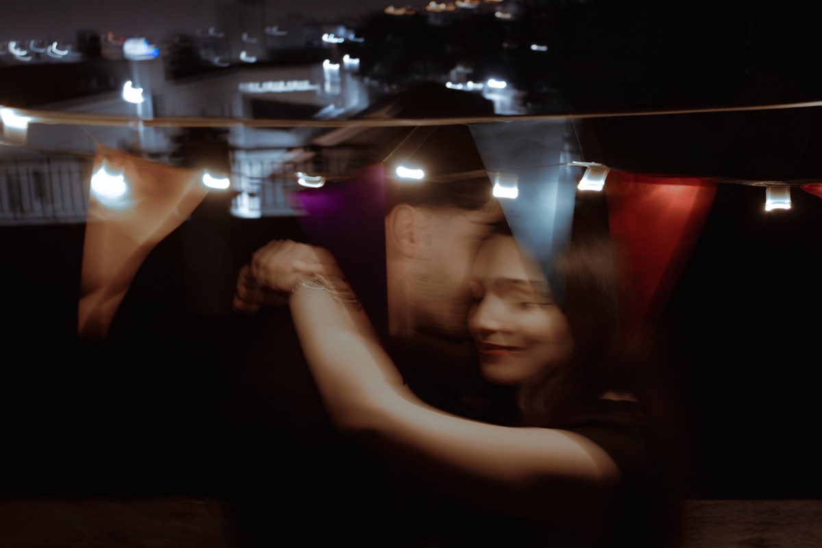 Photograph by Myrto Perifanou — “Rooftop” | Blurred moment between two figures, handheld camera