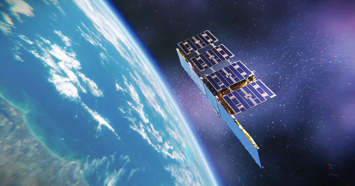 A small ICEYE synthetic aperture radar (SAR) satellite orbiting above Earth, with solar panels extended and Earth’s surface visible below, showing blue ocean, cloud formations, and landmass.