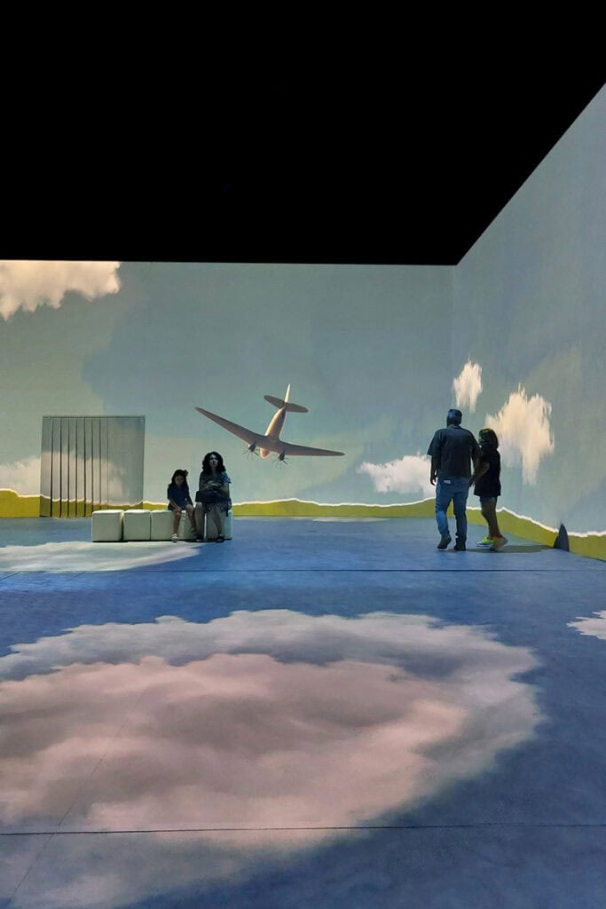Airplane scene projected on walls during Frida Kahlo immersive exhibition in Thessaloniki