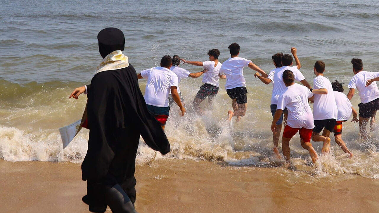Youth dive into the Atlantic during the Holy Cross Celebration