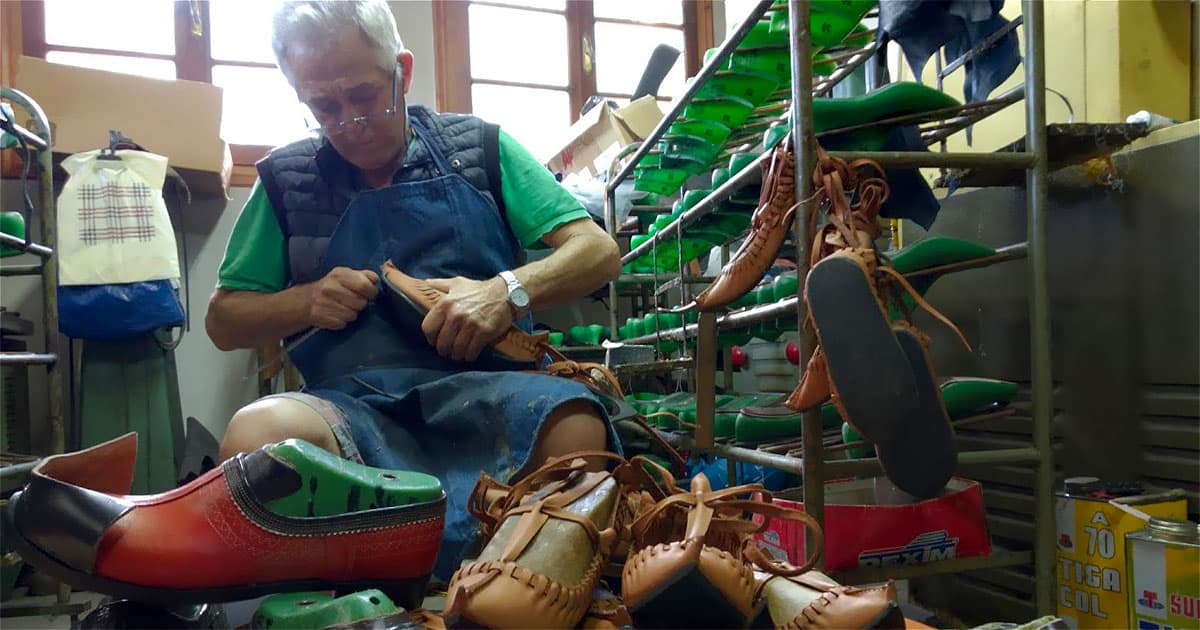 Ilias Kogias crafting tsarouchia and gourounotsaroucha by hand at the Kogias Art traditional footwear workshop in Kastania, Karditsa