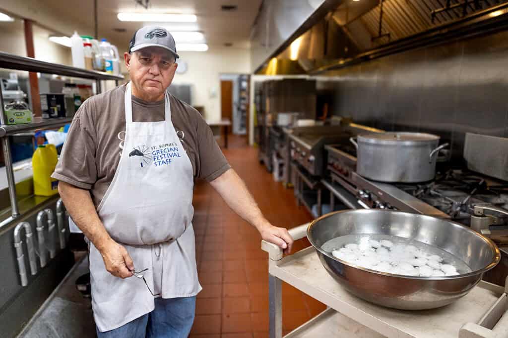 John Pogas preparing meals in the kitchen of St. Sophia Greek Orthodox Church.