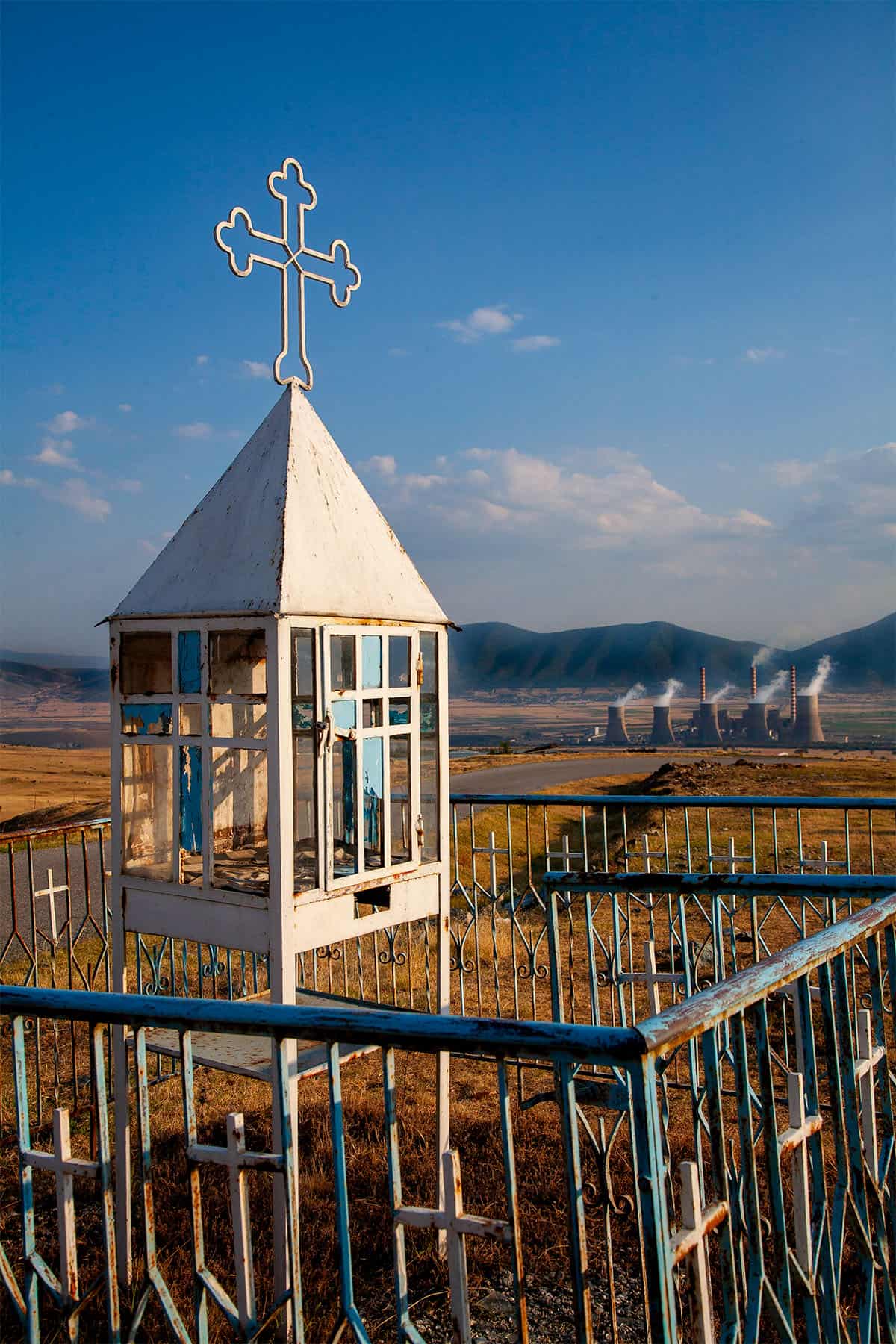 Old pareklisi with a cross overlooking the Ptolemaida power plant in Kozani, Greece.
