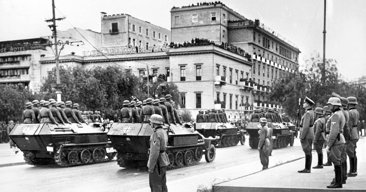 German tanks and soldiers parade through central Athens as locals watch from rooftops, April 27, 1941, during the Nazi occupation of Greece.