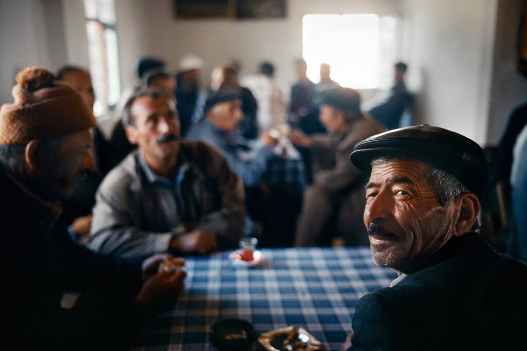 Elderly men gathered inside a rural coffeehouse in Trabzon Province, Turkey.