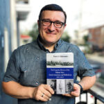 Peter S. Giakoumis holding his book The Forgotten Heroes of the Balkan Wars: Greek-Americans and Philhellenes 1912–1913