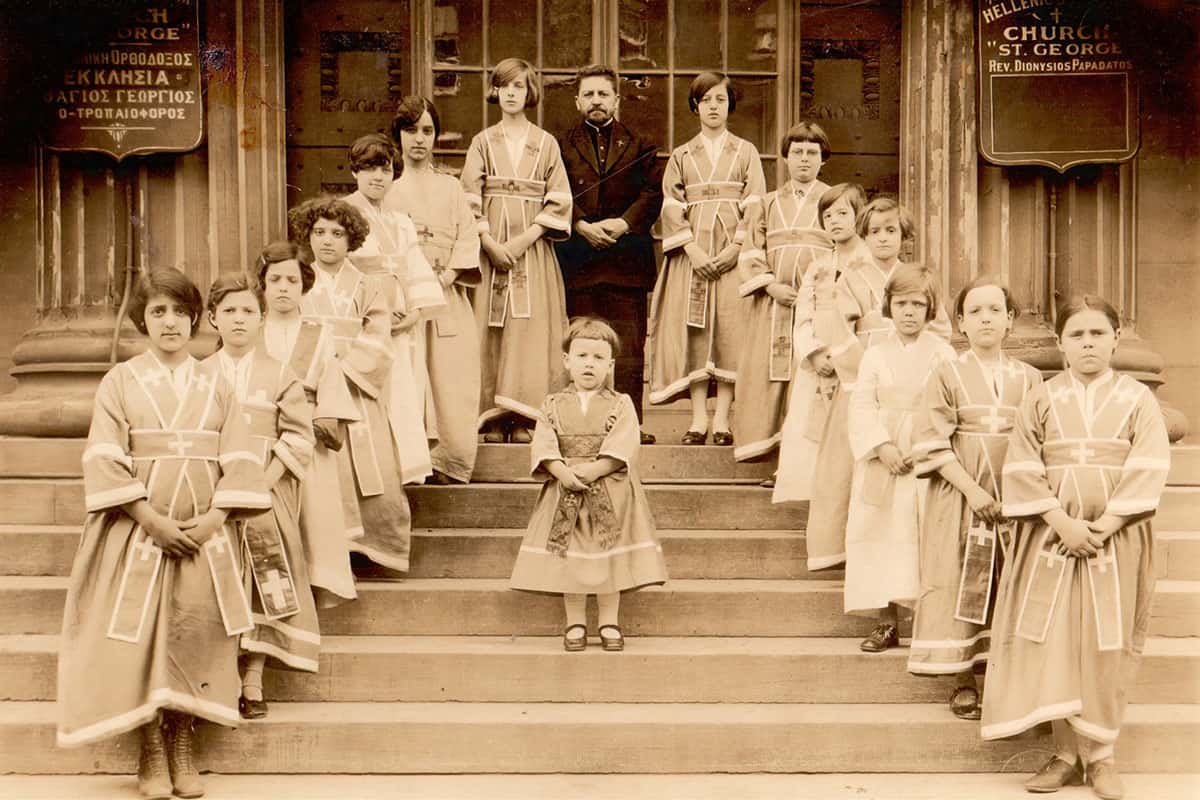 The “Altar Girls of St. George’s Church,” as identified in parish archives, photographed in 1927 with the Very Rev. Dionysios Papadatos on the steps of St. George Cathedral.
