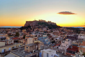 Athens rooftops at sunset with the Acropolis in the background