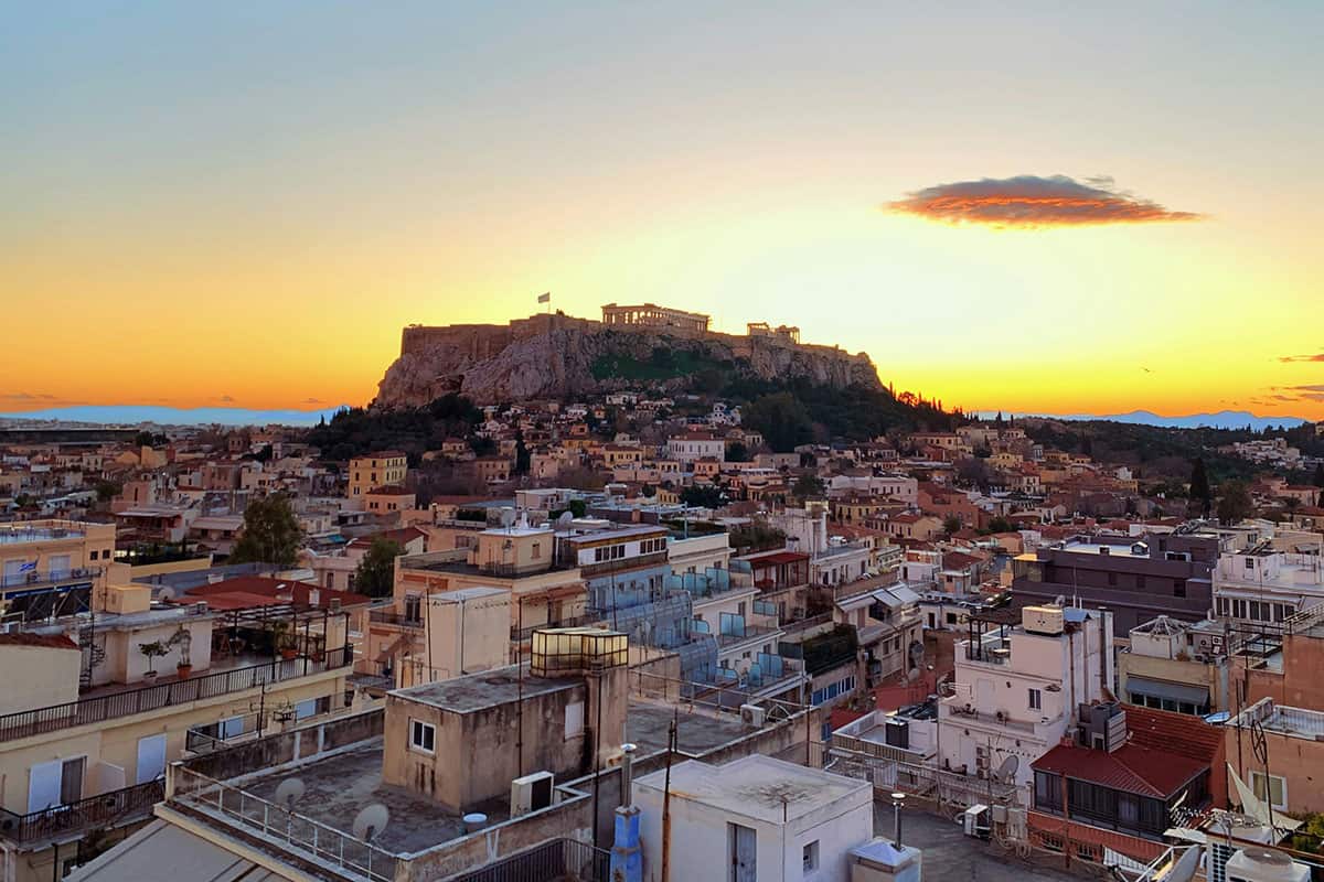 Athens rooftops at sunset with the Acropolis in the background