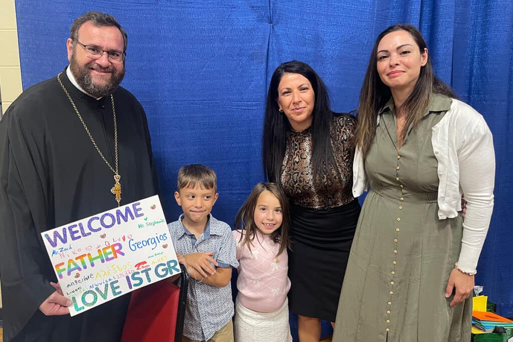 Children present a colorful welcome sign to Father Georgios Oikonomou during the luncheon at Saint Thomas Greek Orthodox Church in Cherry Hill, NJ