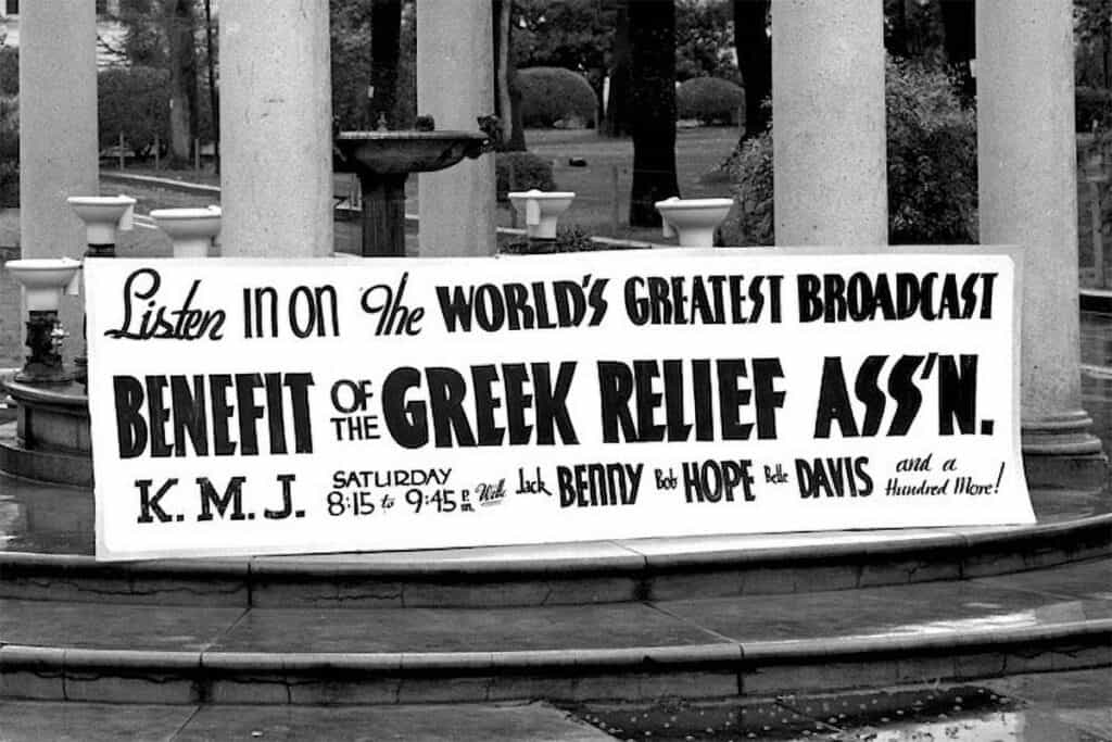 1940s sign advertising a national radio broadcast to benefit the Greek War Relief Association, featuring Jack Benny, Bob Hope and Bette Davis.