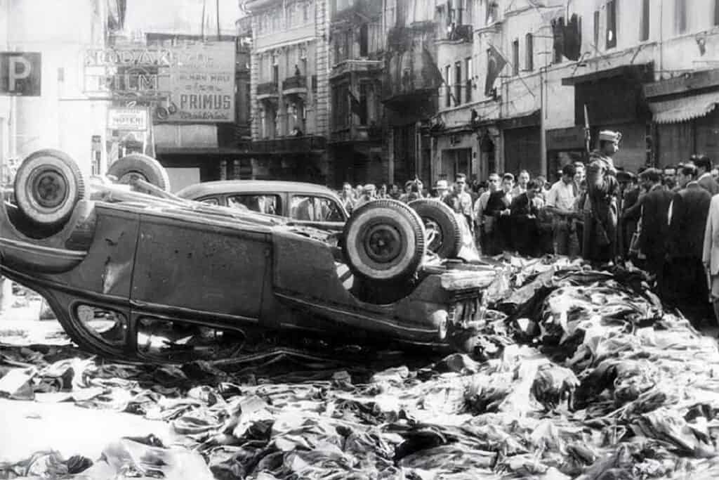 Overturned car and looted goods scattered on the streets of Constantinople during the September 1955 pogrom against the Greek community.