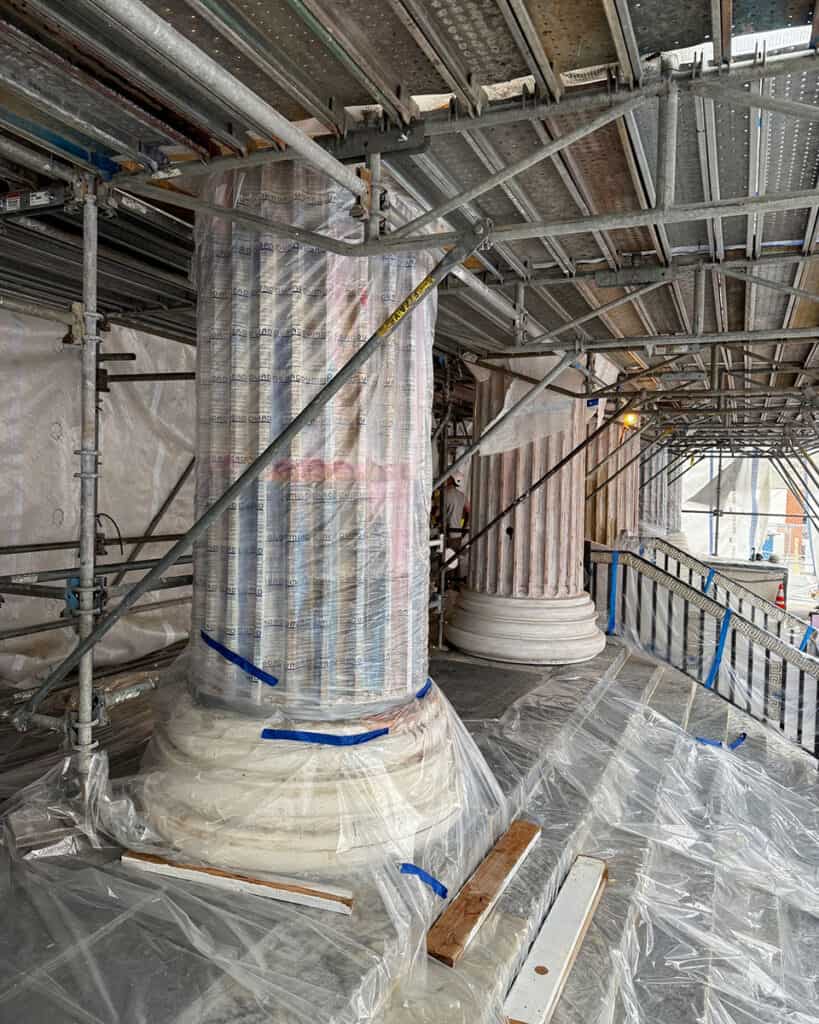 Ionic columns of St. George Cathedral under restoration with scaffolding.