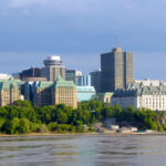 View of downtown Ottawa, Canada, showing government buildings and the Supreme Court of Canada along the Ottawa River.