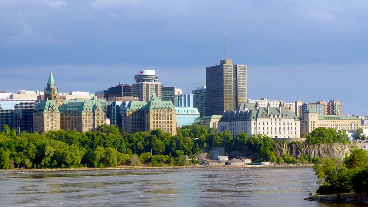 View of downtown Ottawa, Canada, showing government buildings and the Supreme Court of Canada along the Ottawa River.