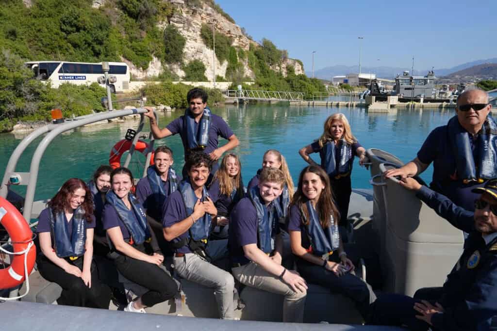 AHIF students ride a rigid inflatable boat (RIB) during a visit to Souda Bay, Crete, as part of the 2025 College Student Foreign Policy Trip.