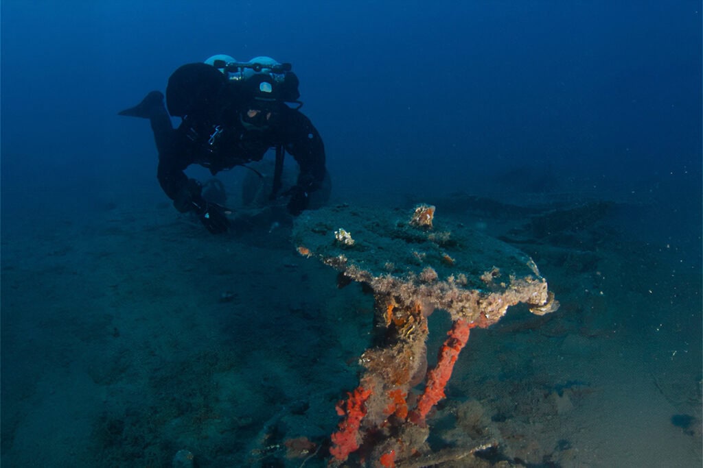 Research diver examining structural remains of the SS Heimara wreck