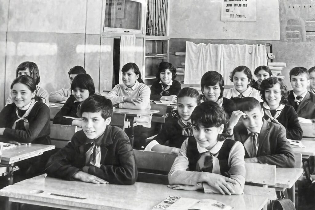 Classroom of Greek refugee children in Tashkent during the 1970s, smiling and attentive as they study the Greek language inside a Soviet-era school.