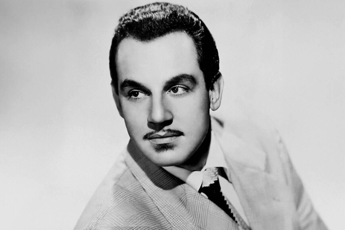 Black-and-white studio portrait of Johnny Otis, a Greek American musician and producer.