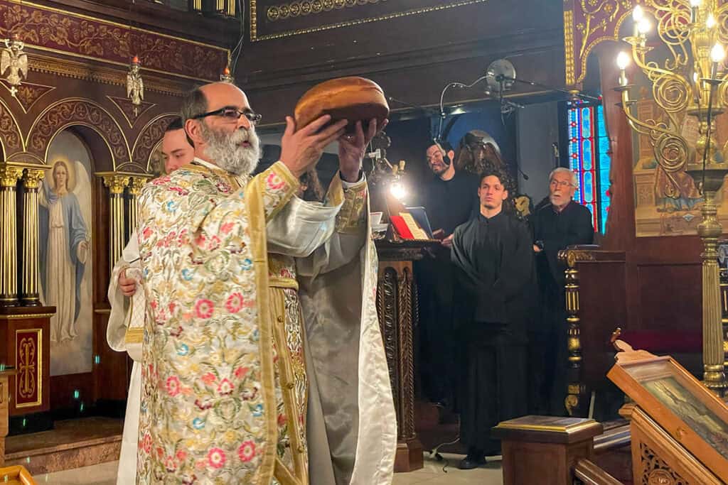 Priest holds the Vasilopita during the blessing service at St. George Greek Orthodox Cathedral.