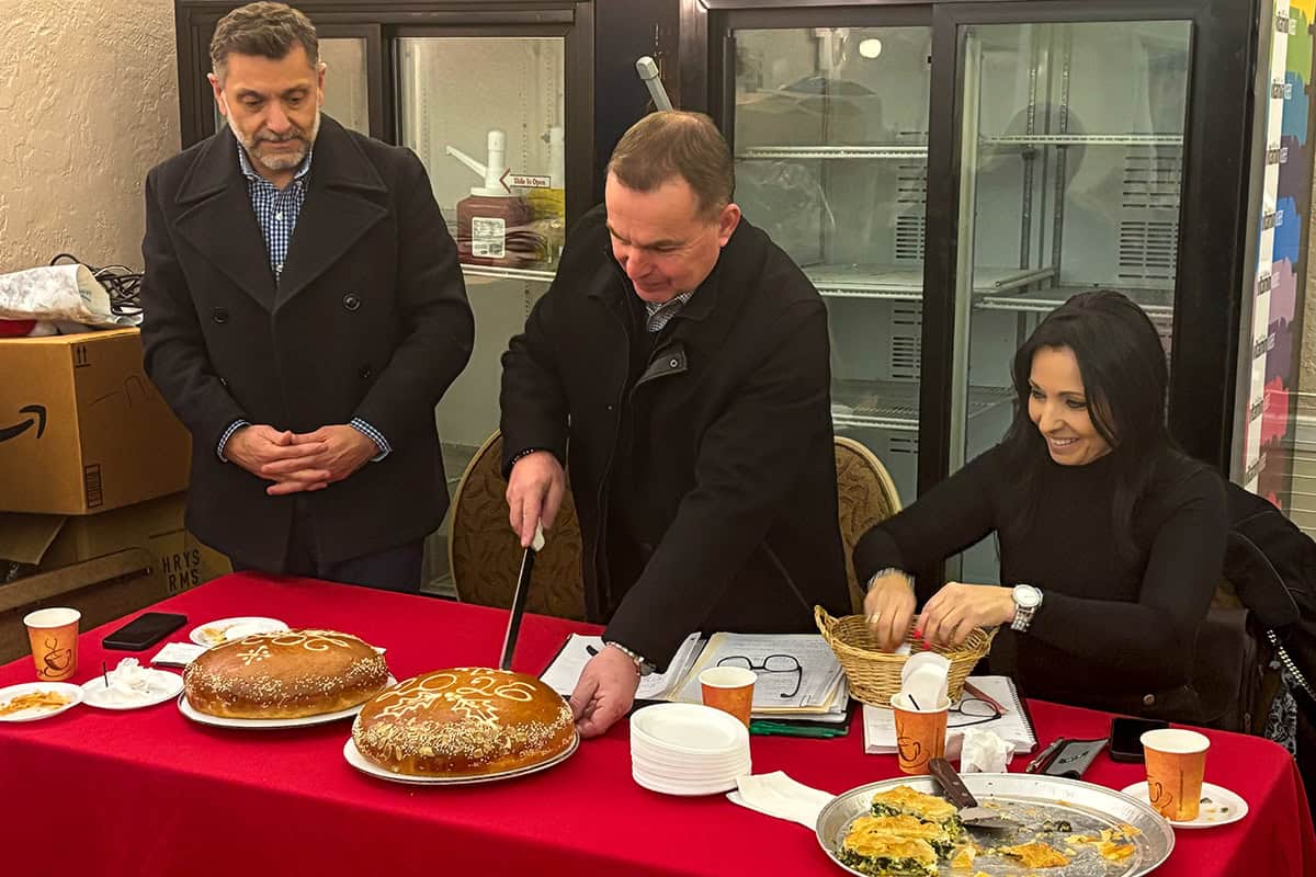 Members of the Society of Epirotes of Philadelphia cut the Vasilopita during the annual general assembly.