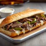 Philly cheesesteak sandwich served on a tray with melted cheese and sliced beef