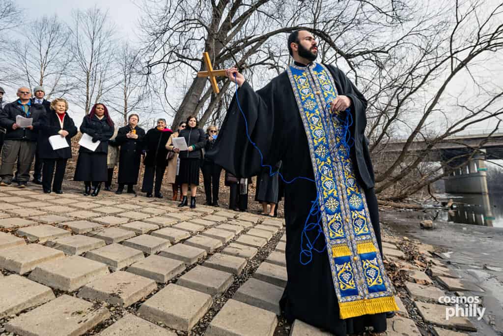 The cross is drawn back from the river by a cord after the blessing of the waters.