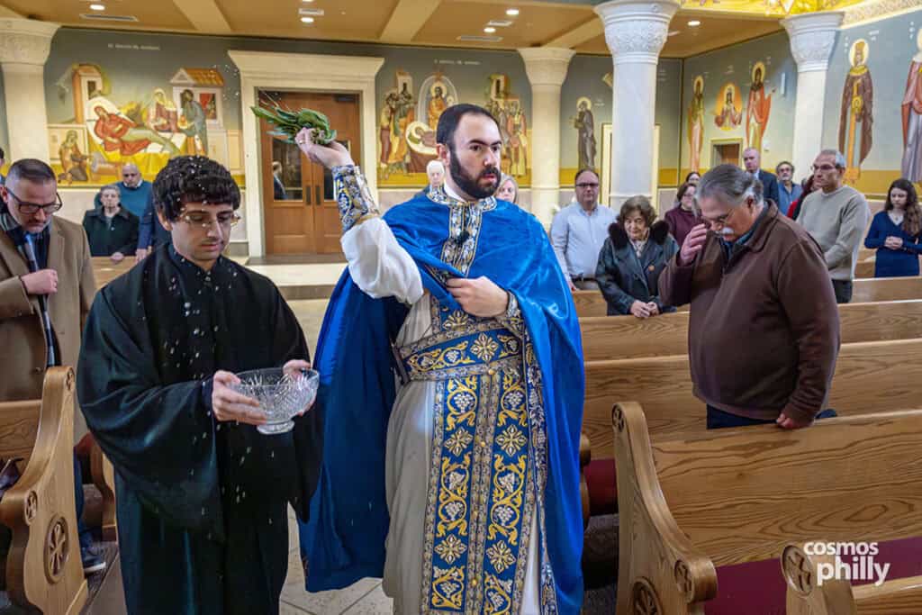 Holy water is sprinkled with basil branches during the Orthodox Theophany service.