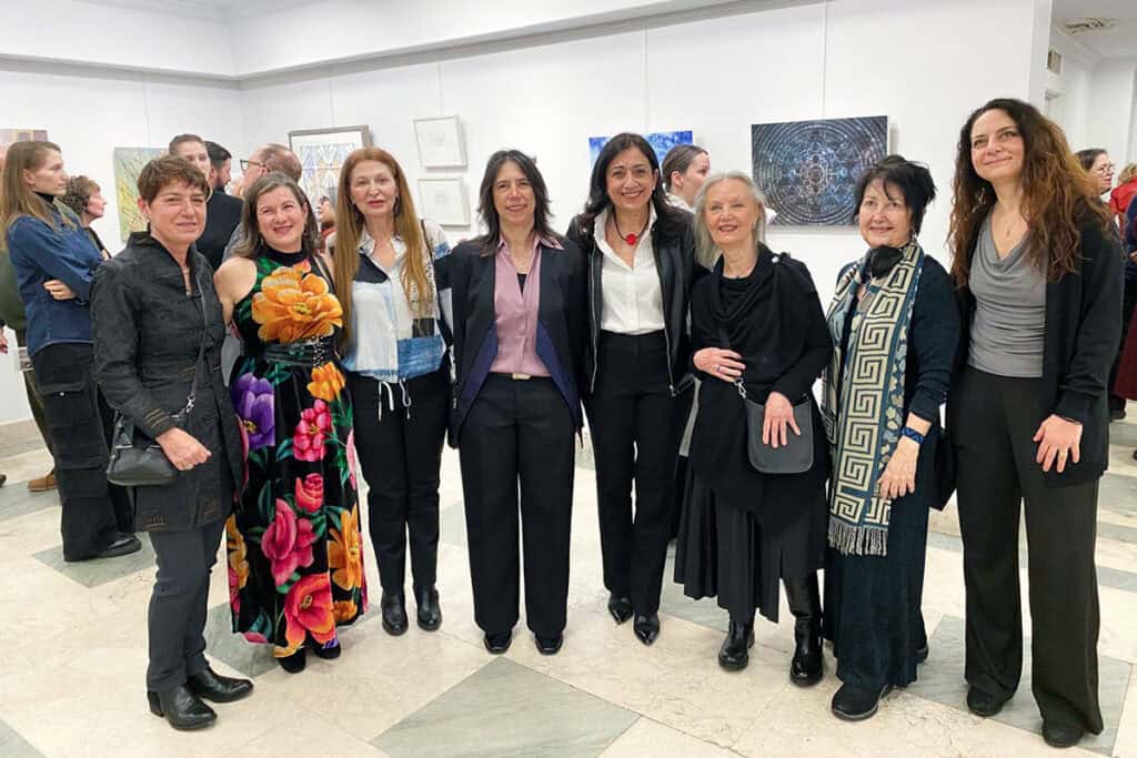 Participating Greek-American women artists pose together during the exhibition opening at the Greek Consulate in New York.