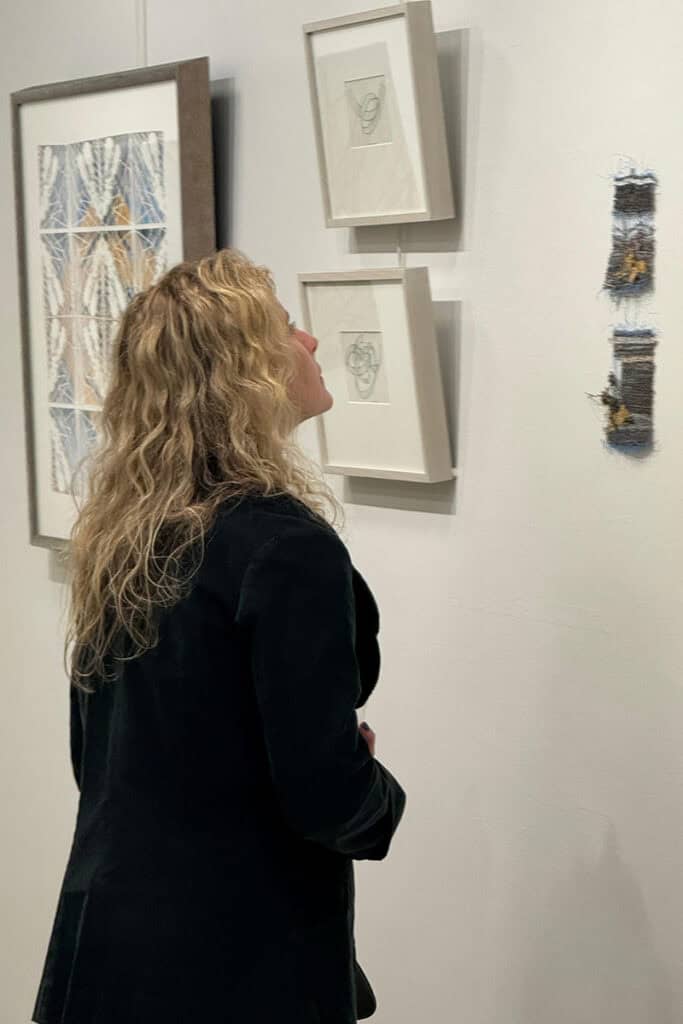 A visitor looks at artwork displayed during the Greek-American women artists exhibition at the Greek Consulate in New York.
