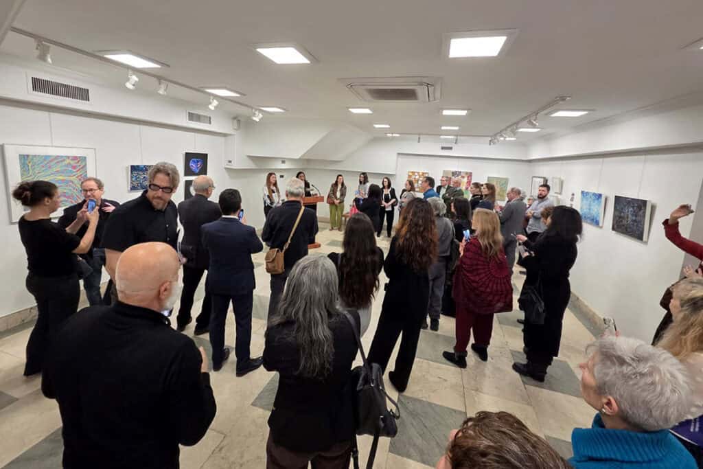 Visitors view artwork displayed at the Greek-American women artists exhibition at the Greek Consulate in New York.