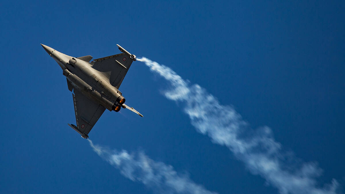 Dassault Rafale fighter jet flying against a blue sky