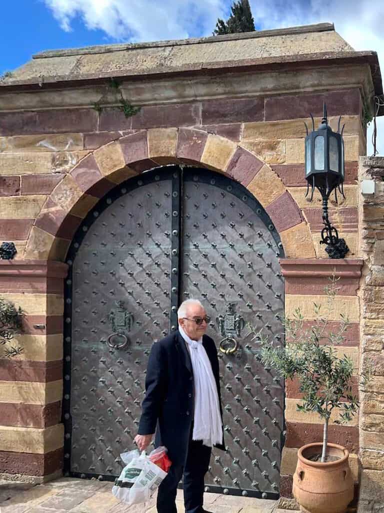 Lorenzo Argenti standing before the gate of the Argentikon estate in Kambos, Chios