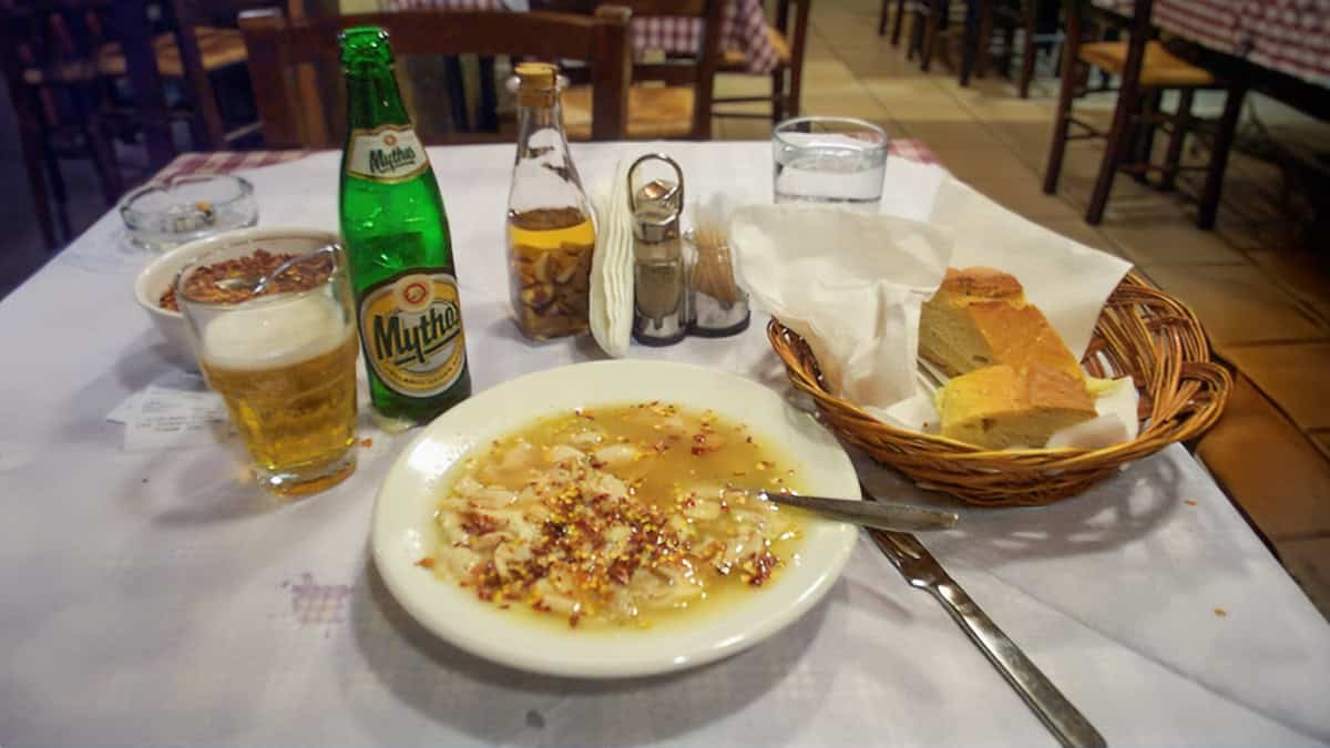 A plate of patsas on a restaurant table in Greece
