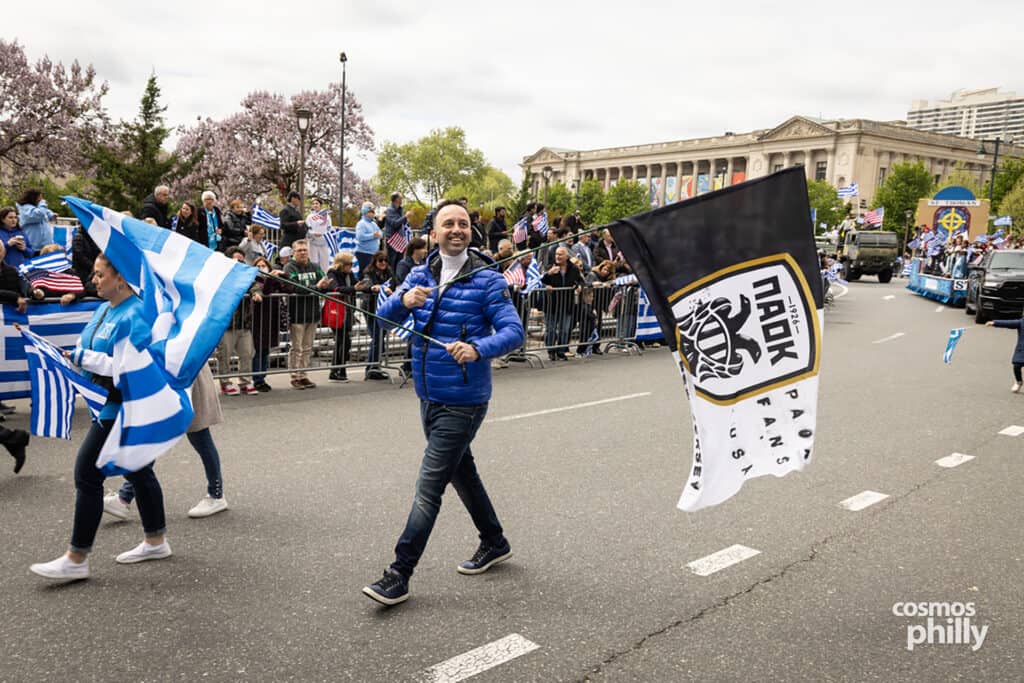Participants carrying Greek and PAOK flags during the annual Greek Independence Day Parade in Philadelphia.
