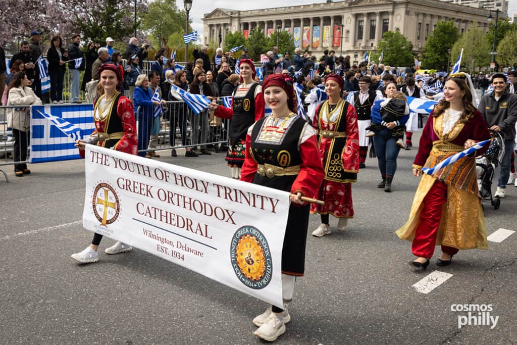 Parish communities marching with banners during the 2026 Philadelphia Greek Independence Day Parade.