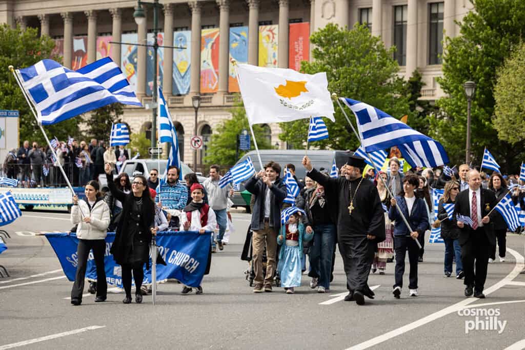 Participants carrying Greek and Cyprus flags during the annual Greek Independence Day Parade in Philadelphia.