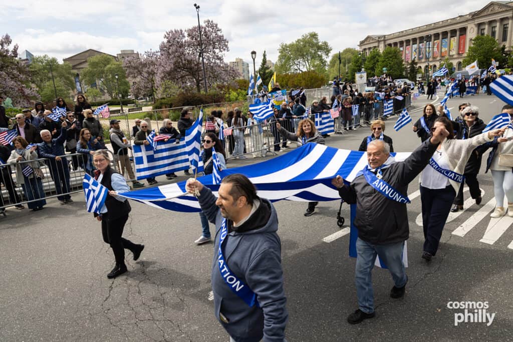 Participants carrying Greek flags during the annual Greek Independence Day Parade in Philadelphia.