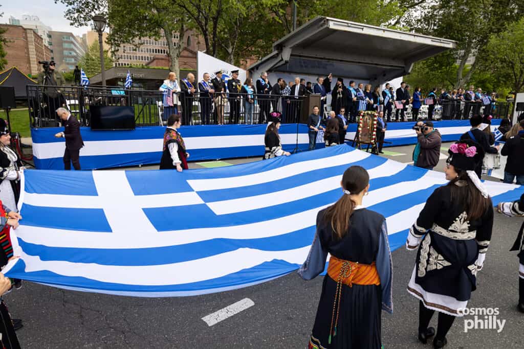 Participants carrying Greek flags during the annual Greek Independence Day Parade in Philadelphia.
