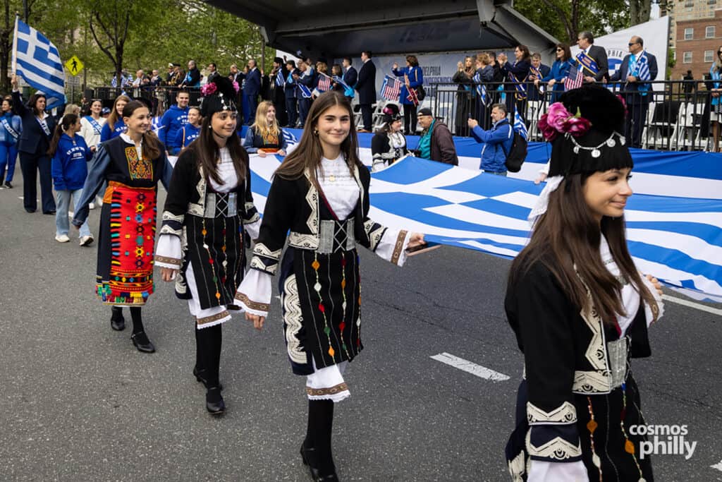 Participants carrying Greek flags during the annual Greek Independence Day Parade in Philadelphia.