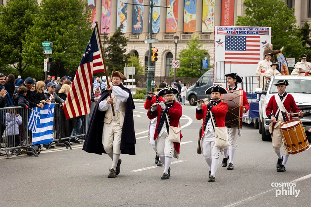 Participants carrying flags during the annual Greek Independence Day Parade in Philadelphia.
