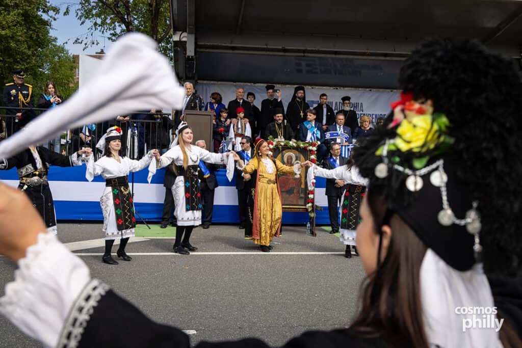 Greek dance groups in traditional dress during the 2026 Philadelphia Greek Independence Day Parade.
