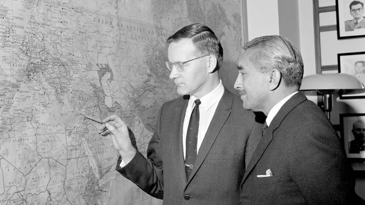 Major General D. Prem Chand and Lt. Col. Lauri Koho look at a wall map during a 1969 United Nations meeting related to the Cyprus peacekeeping force.