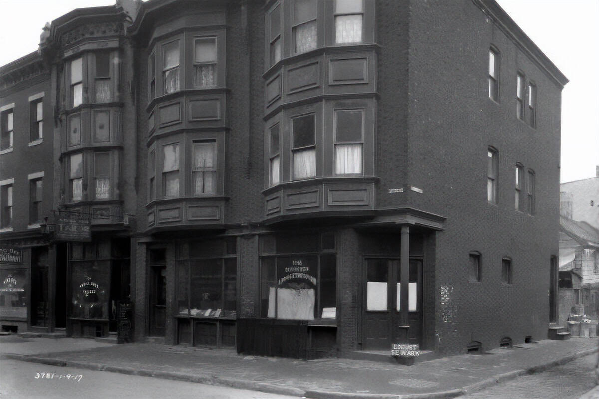 1917 photograph of Greek storefronts at 1018 Locust Street in Philadelphia, including a window marked in Greek as a kafeneion.