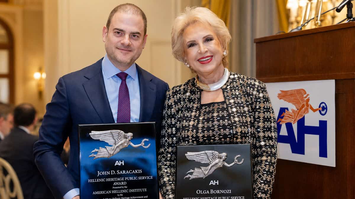 Olga Bornozi and John D. Saracakis hold their AHI awards at the 21st Annual Athens Hellenic Heritage Achievement and Public Service Awards Dinner.