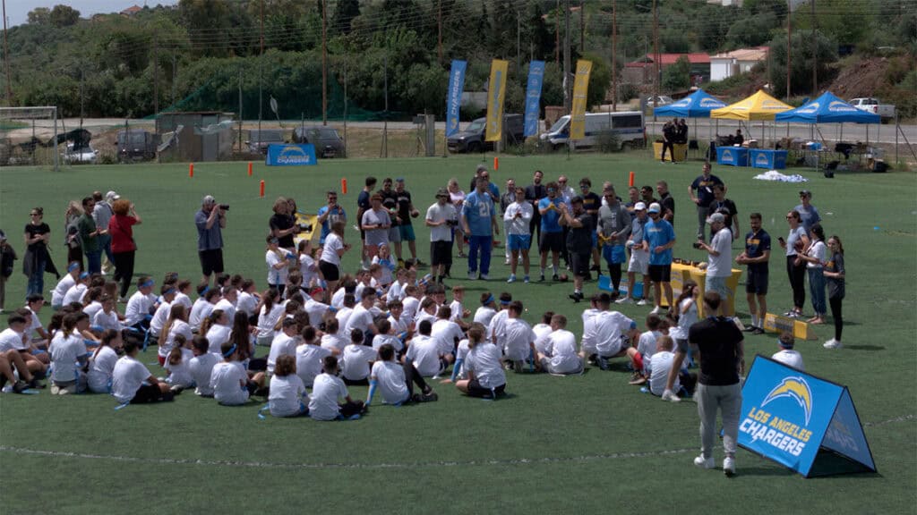 Young participants doing flag football drills at the Los Angeles Chargers NFL Flag Football Camp in Methoni.