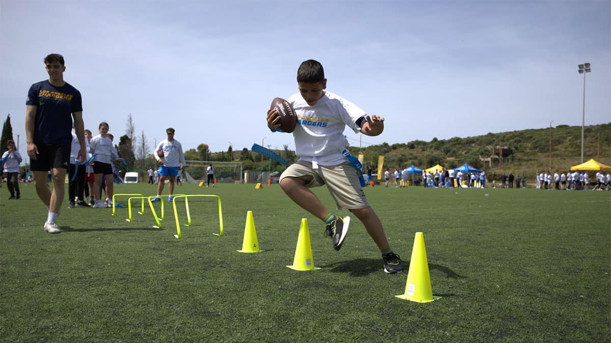 Children taking part in the Los Angeles Chargers NFL Flag Football Camp in Methoni, Messinia.