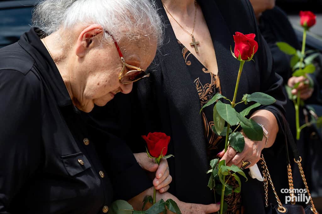 A woman holds a red rose during the Pontian Genocide remembrance ceremony in Upper Darby.